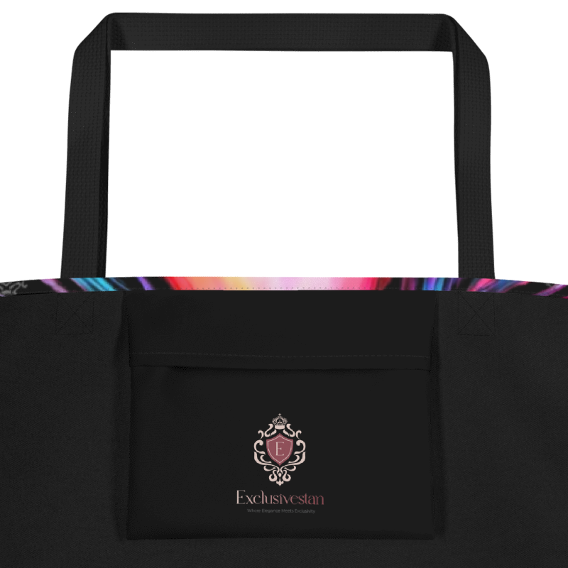 A black tote bag with black shoulder straps, a front pocket featuring a pink and gold Exclusivestan logo, and a colorful rainbow pattern visible along the top edge, shown against a plain white background.